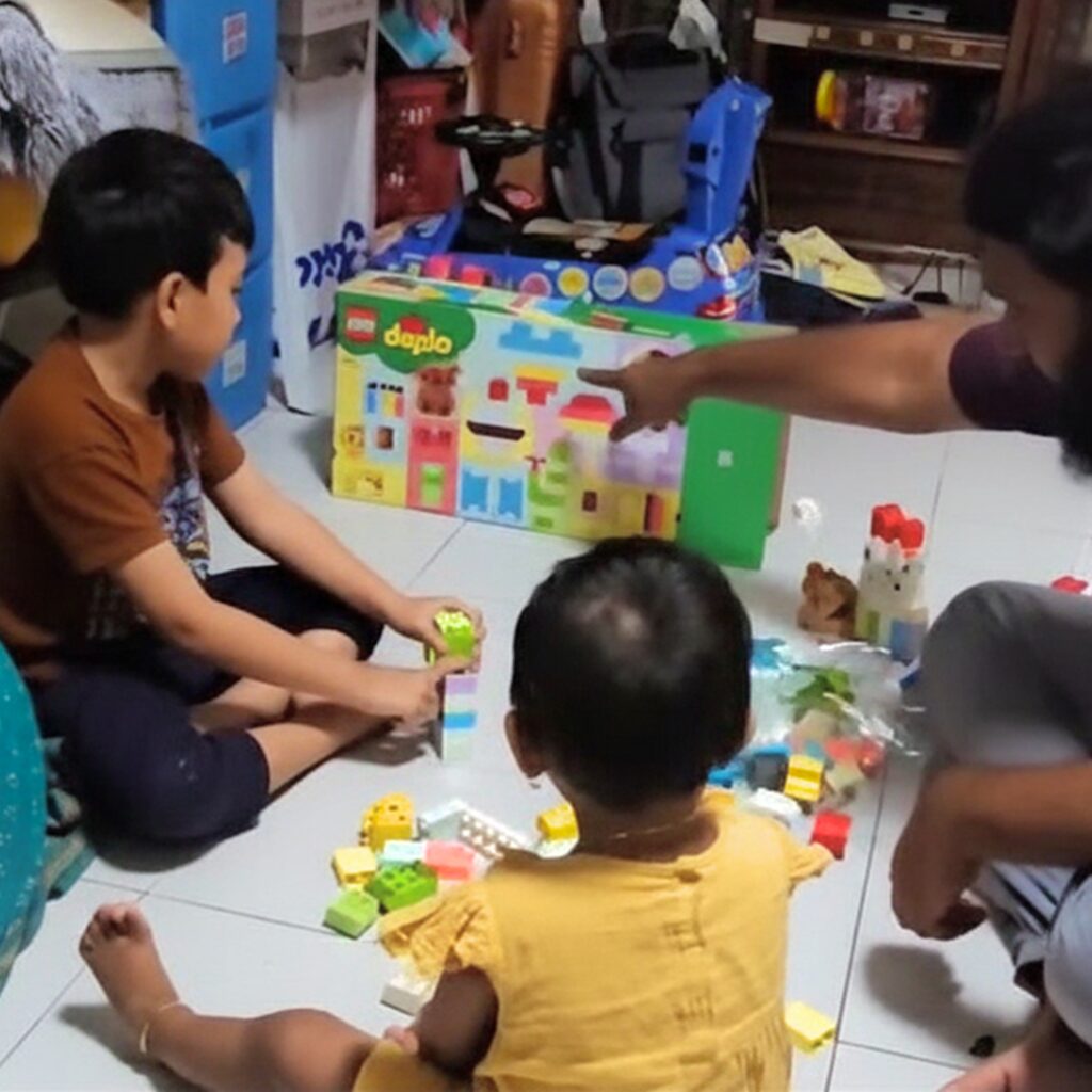 Parents and children strengthening family bonds through play at KidSTART - The Lego Project.